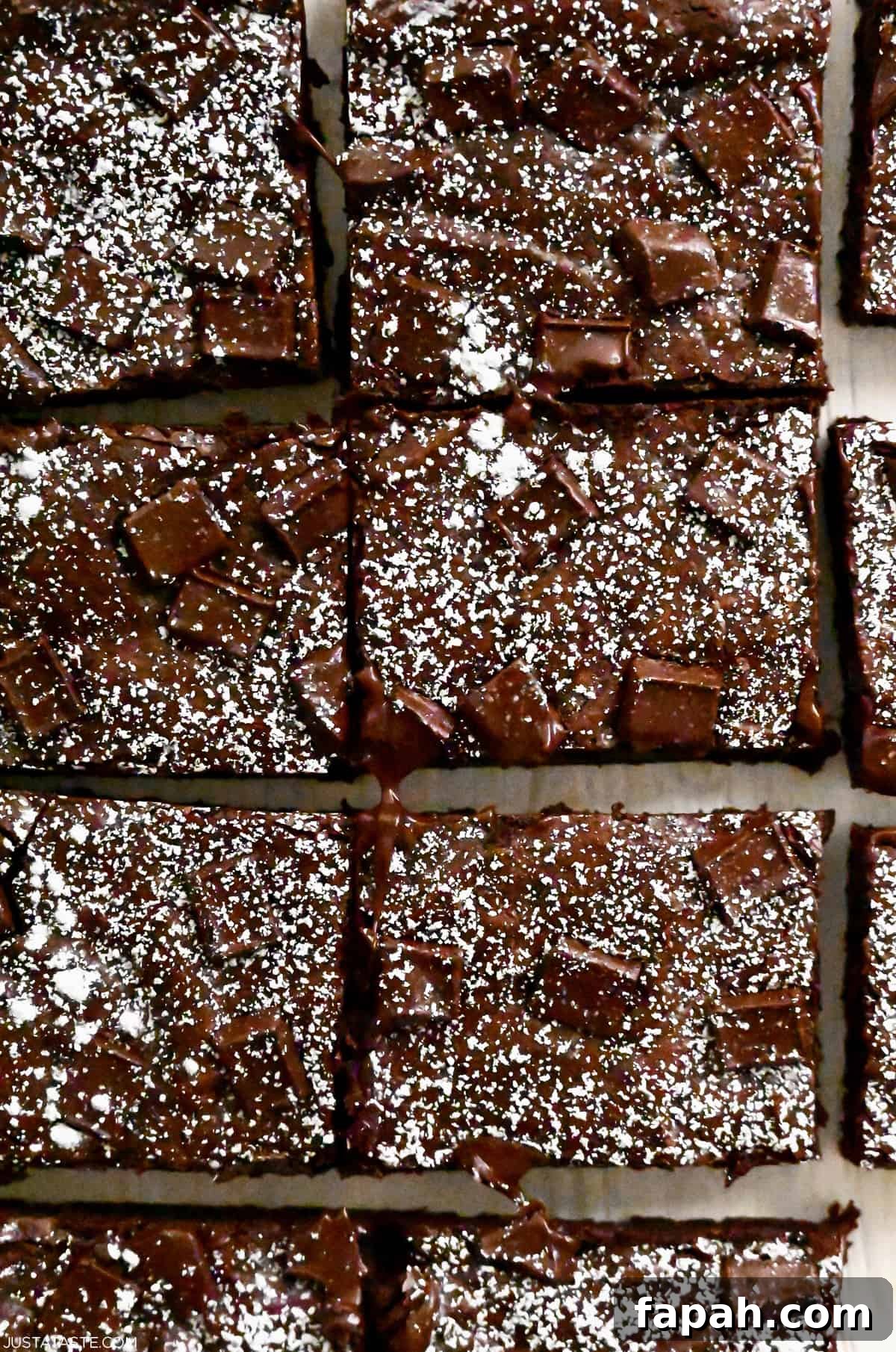 Fudgy Cocoa Brownies Recipe: Rich, Chewy Homemade Treat 3 Brownies cut into perfect rectangles and dusted with powdered sugar.