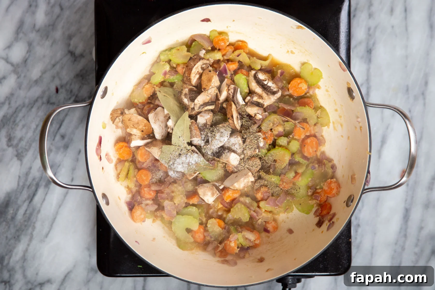 veggie frying in a deep sauteeing pan 