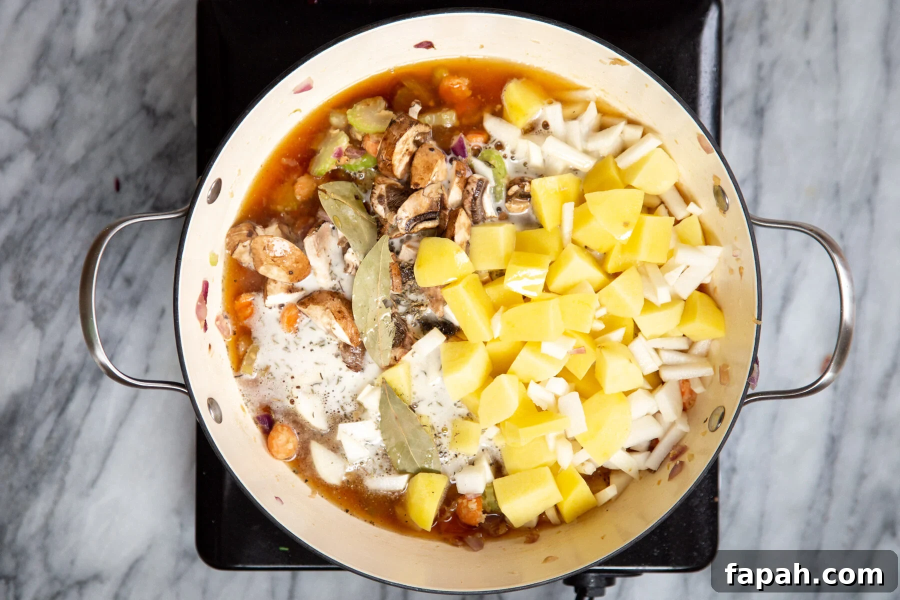 stew ingredients being added to a pot to make vegan Irish Stew 