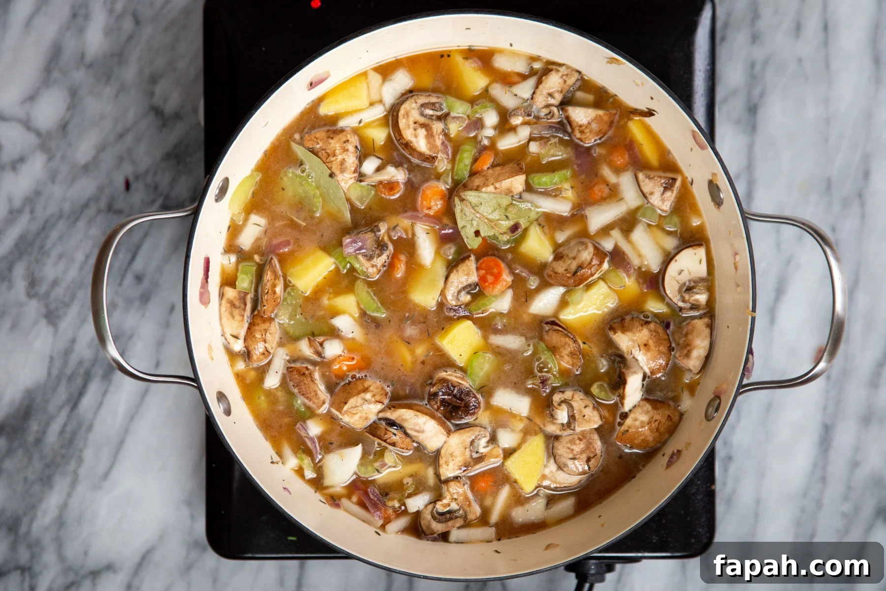 a pot of vegan Irish Stew on a hot plate 