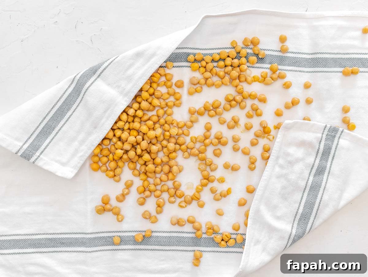 patting chickpeas dry with a kitchen towel
