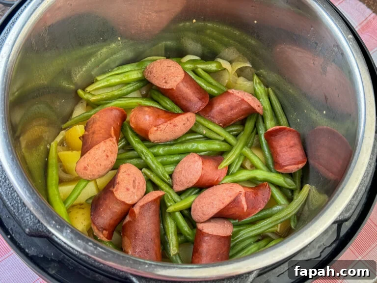 Sausage, green beans and potatoes cooked in the Instant Pot with the lid removed.