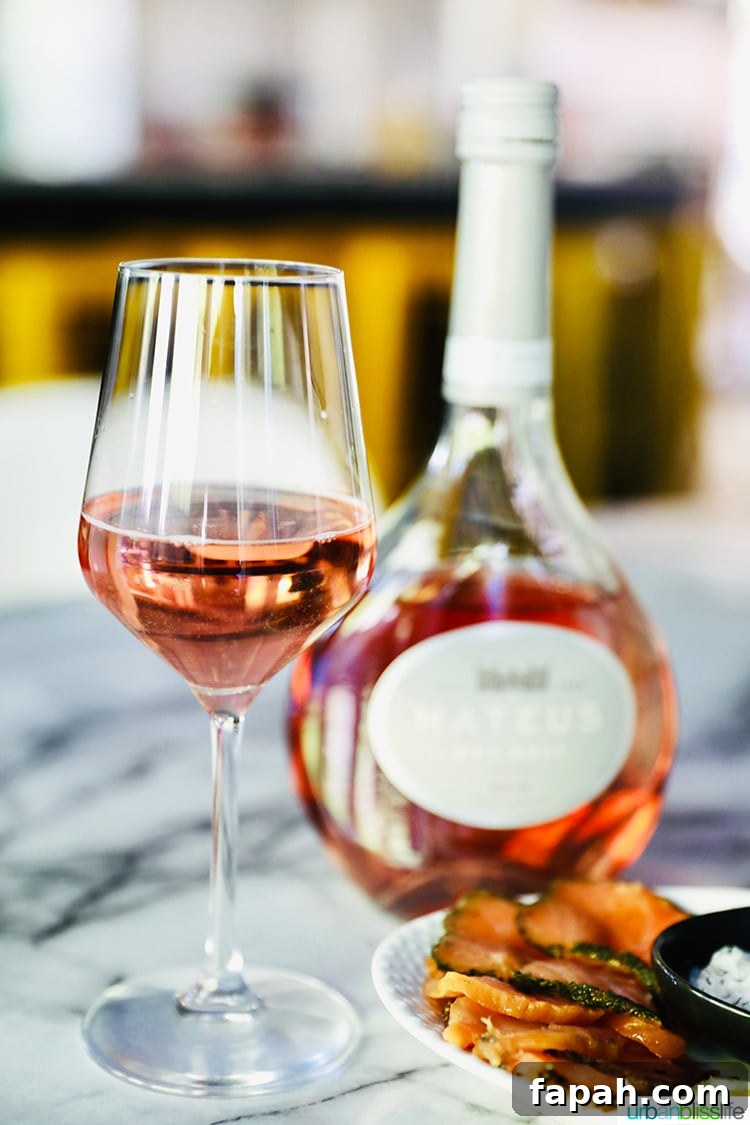 Mateus Rosé wine glass and bottle behind it