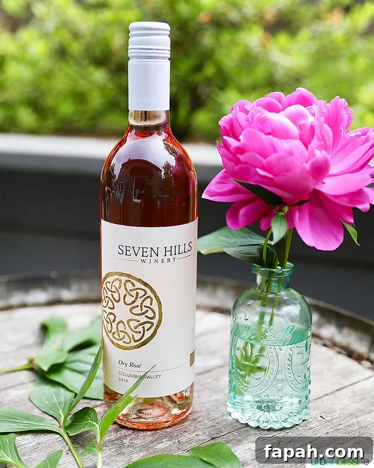 Seven Hills Winery 2019 Rosé wine bottle with pink flower in vase