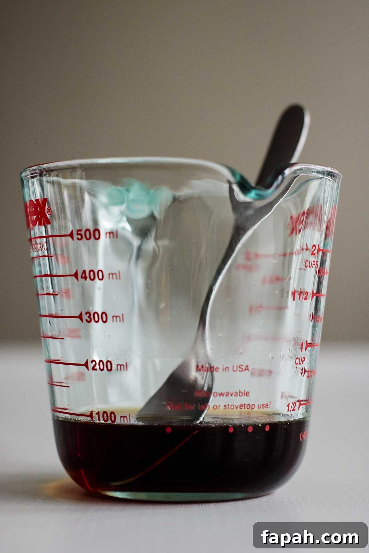 Brown sugar syrup inside a heat proof measuring cup.