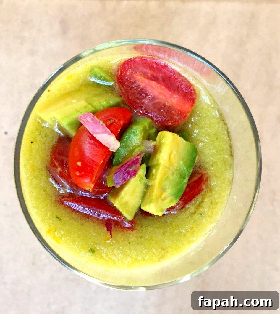 Chilled Avocado, Cucumber & Melon Soup Recipe for Summer 5 Yellow Gazpacho garnished with avocado, tomatoes, and chopped red onions