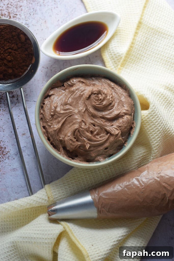 Chocolate buttercream frosting in a small bowl.