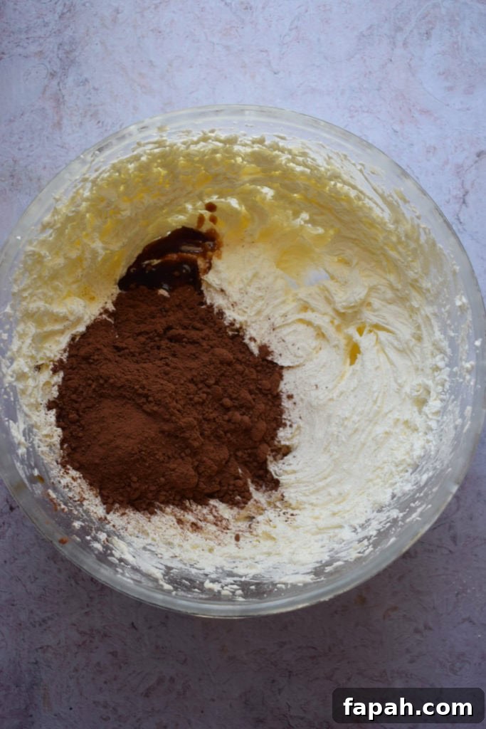 Making chocolate buttercream in a glass bowl.