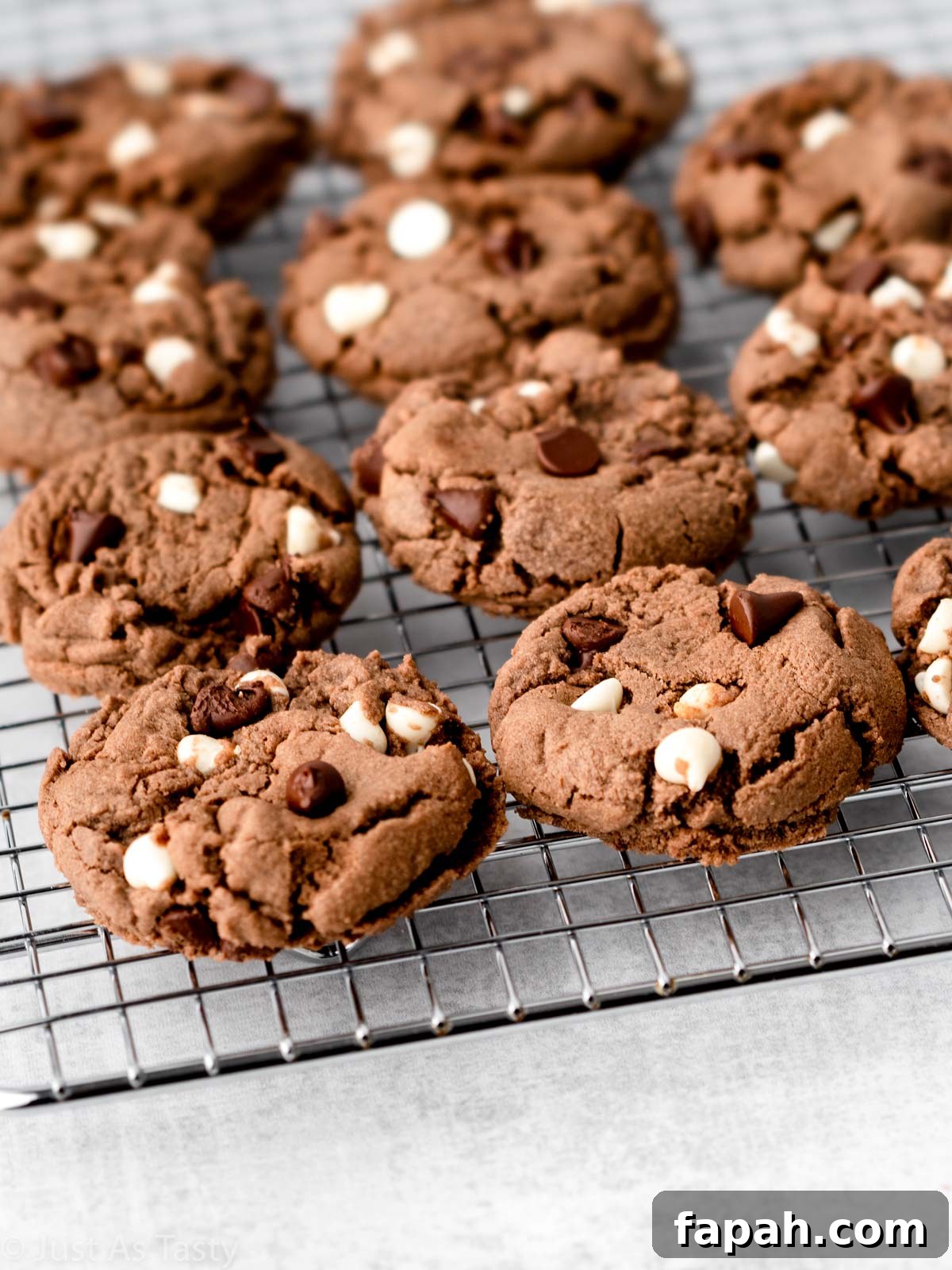 Triple Chocolate Chip Cookies — Gluten-Free Recipe 3 Triple chocolate cookies on a wire cooling rack.