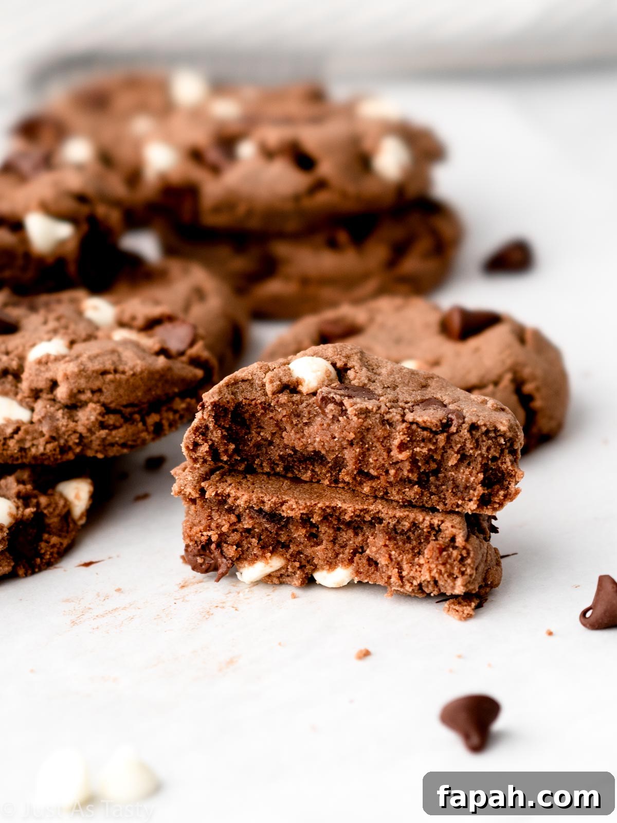 Triple Chocolate Chip Cookies — Gluten-Free Recipe 4 Close-up of a triple chocolate cookie cut in half.