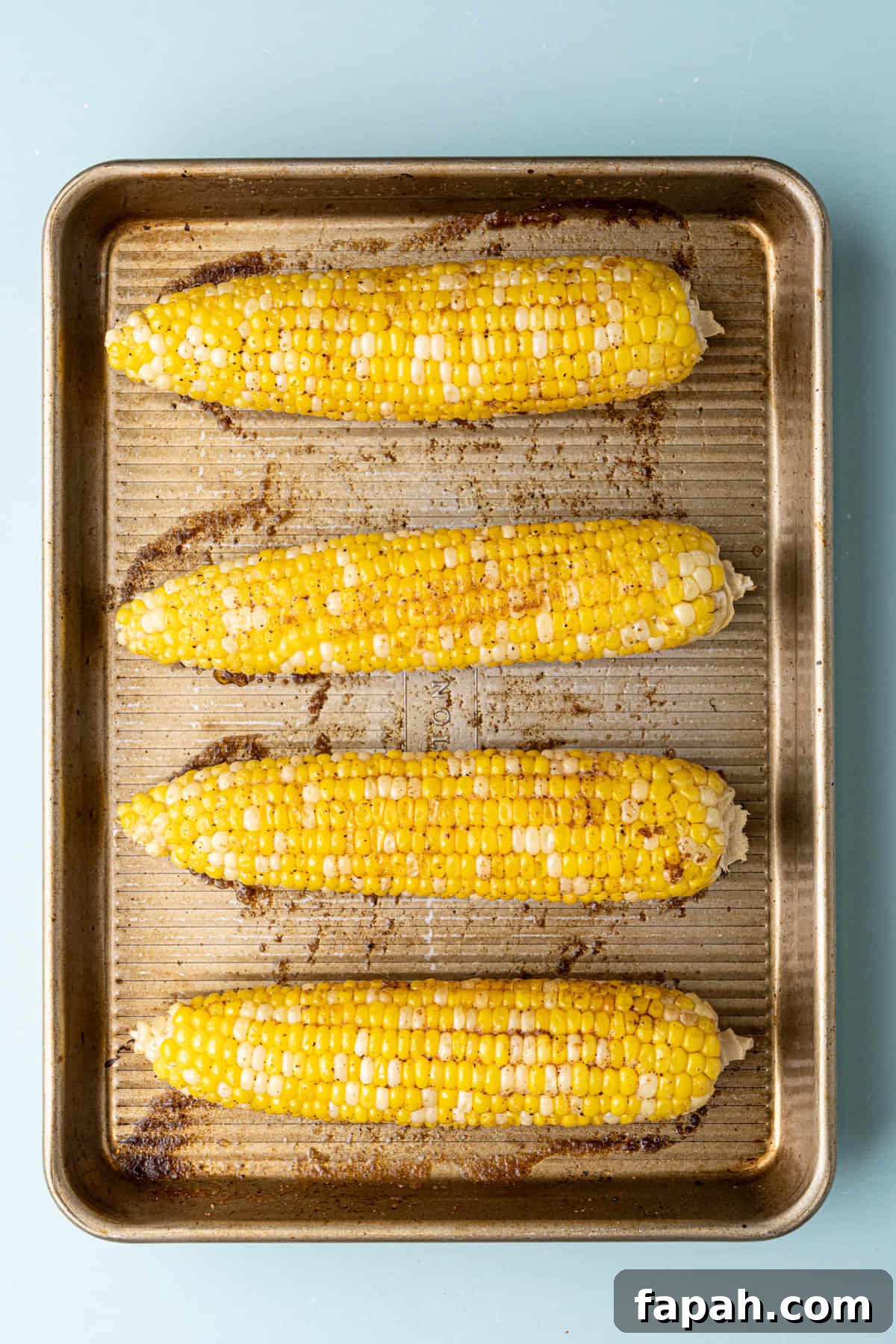 Cajun Roasted Corn on the Cob fresh out of the oven still on the baking tray.