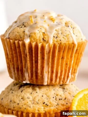 A stack of orange poppy seed muffins with glaze.
