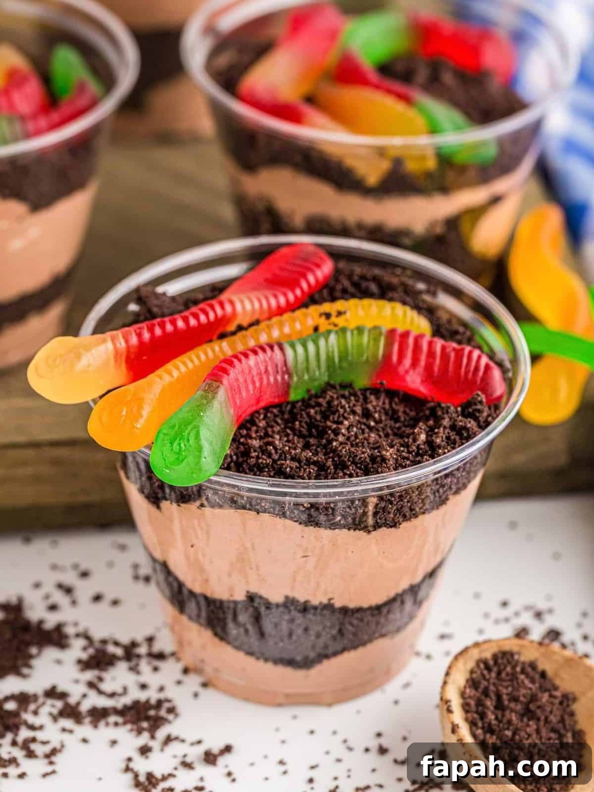 Dirt cake cups topped with gummy worms.