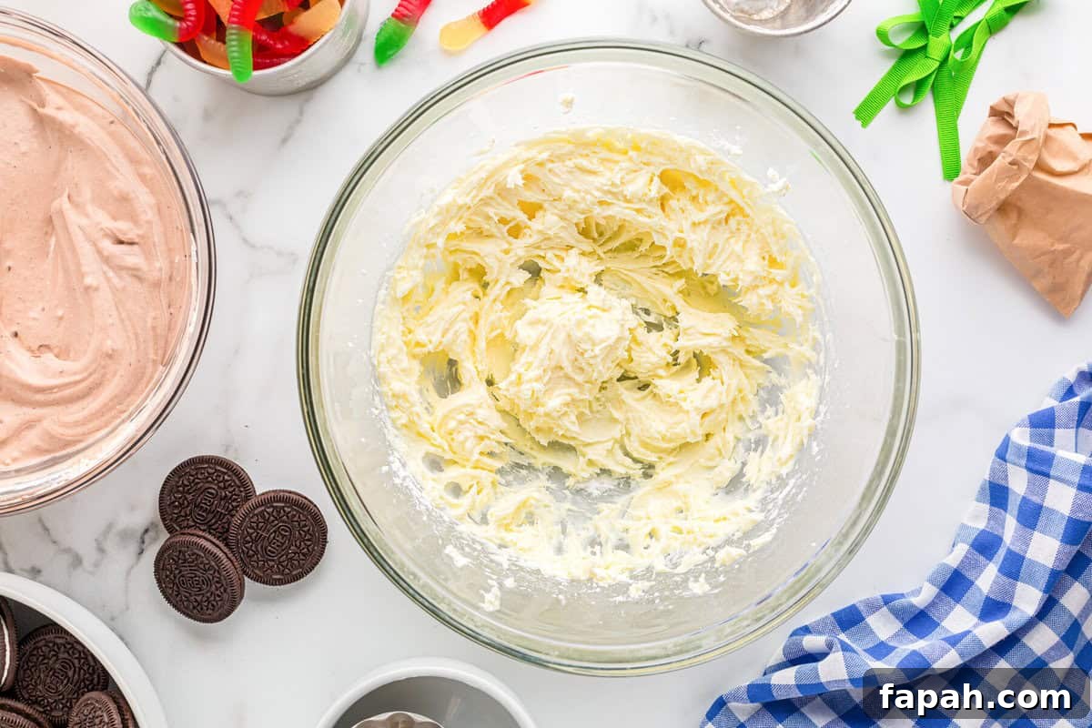 Creamed butter and cream cheese in a glass bowl.