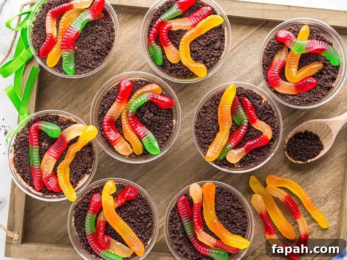 Dirt pudding cups topped with crushed Oreo cookies and gummy worms.