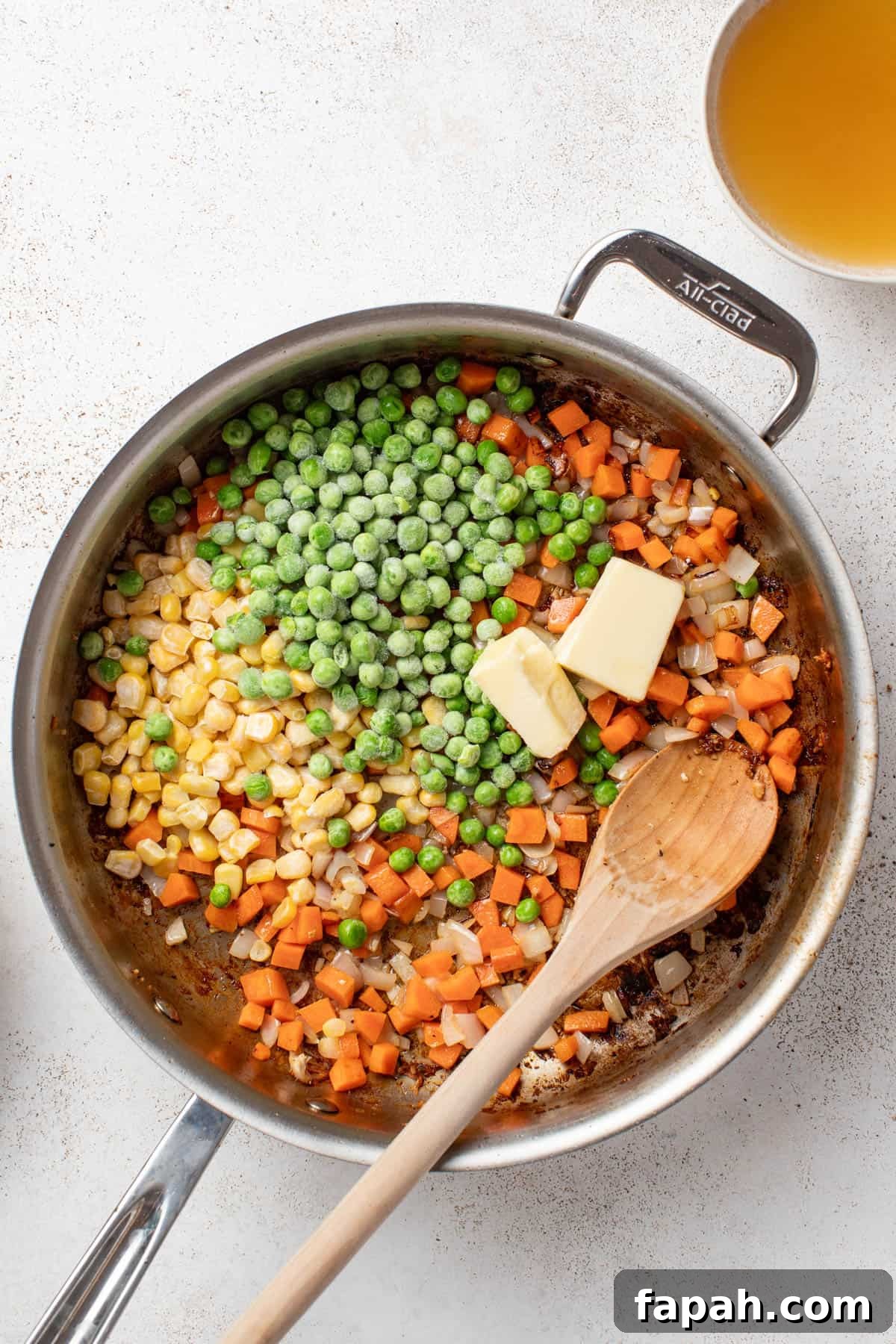 Cooking the vegetables in a stainless still pan.