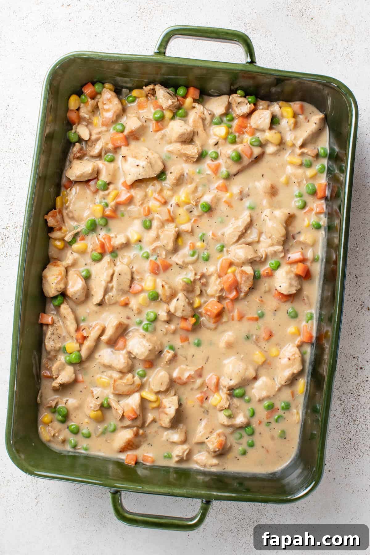 Crustless chicken pot pie in a green baking dish.