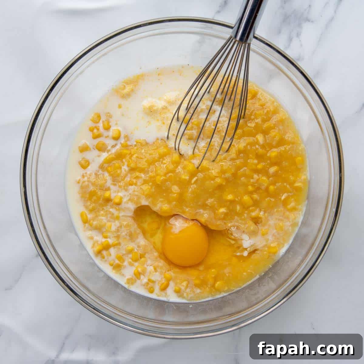 cornbread layer whisked together in a bowl.
