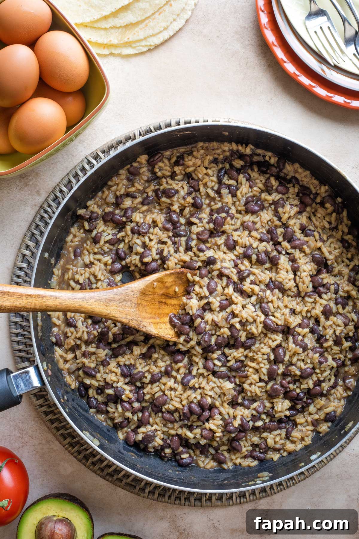 Overhead of step #7 with beans stirred into rice for the "speckled rooster" look the recipe is named for.