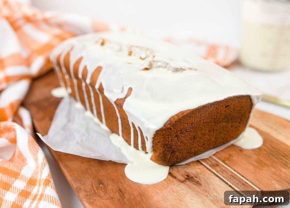 Ultimate Gluten-Free Pumpkin Bread Recipe for Moist Fall Loaves 8 white chocolate icing dripping on a loaf of homemade pumpkin bread