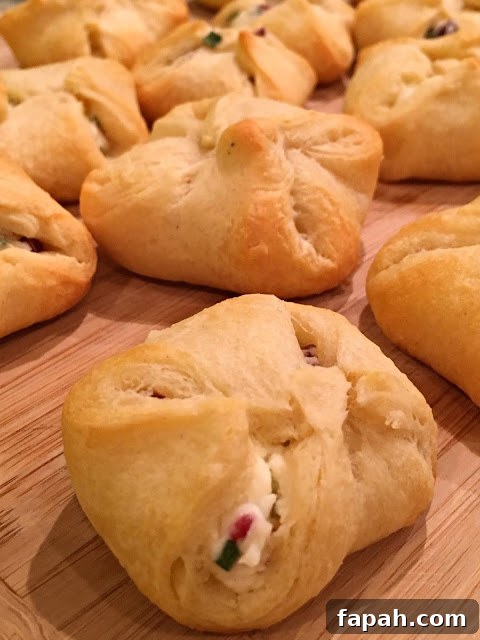 Cranberry and Cream Cheese Crescent Bites – 5-Ingredient Appetizer 3 This photo shows the crescent bites after baking, ready to eat on a cutting board.