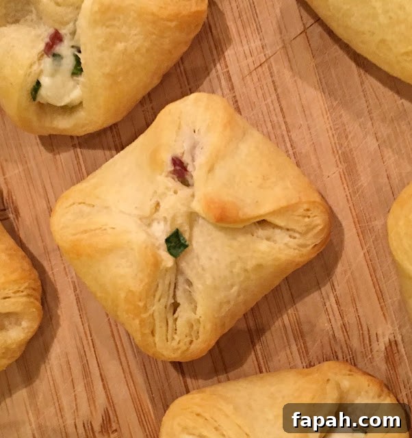 Cranberry and Cream Cheese Crescent Bites – 5-Ingredient Appetizer 4 This photo shows the crescent bites after baking, ready to eat on a cutting board.