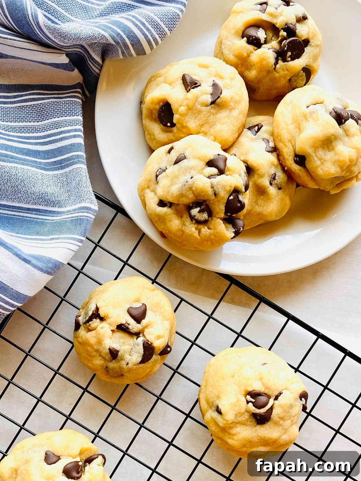 Chocolate Chip Cookies Made Without Brown Sugar: Soft & Crispy Recipe 2 cookies without brown sugar on plate next to baking tray of cookies cooling