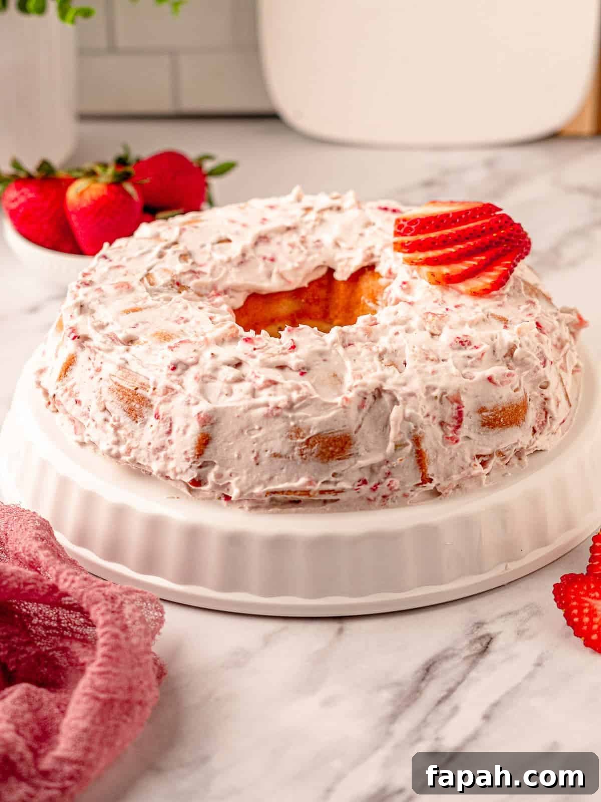 Strawberry bundt cake on a white plate.