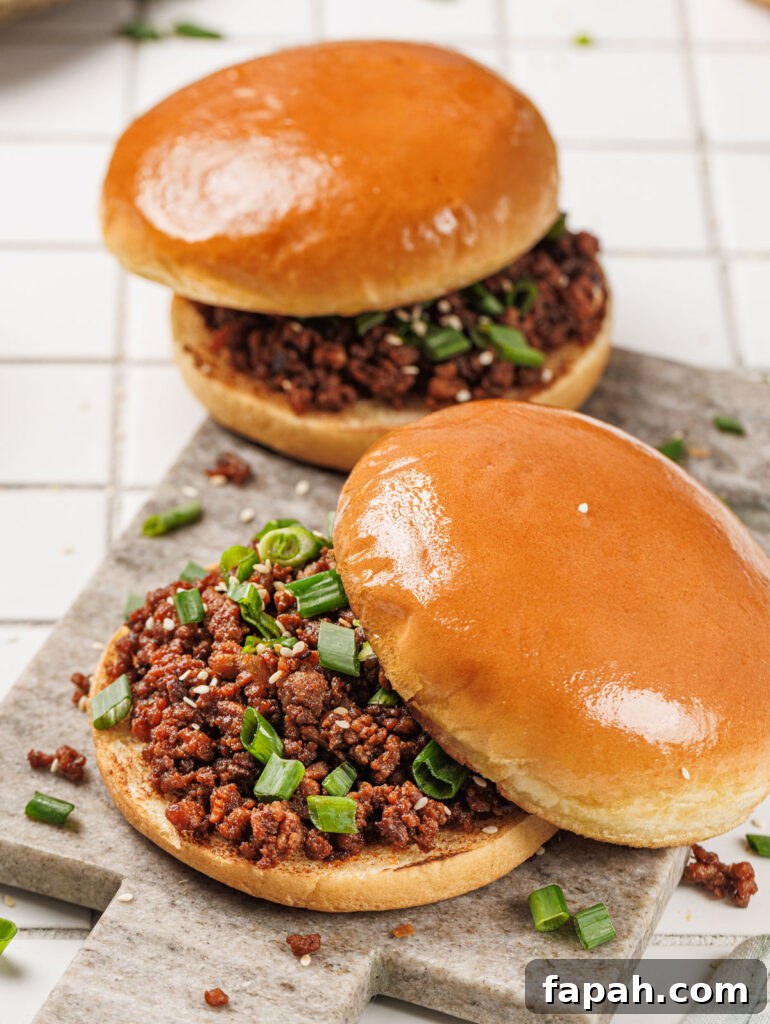 two korean sloppy joes on cutting board