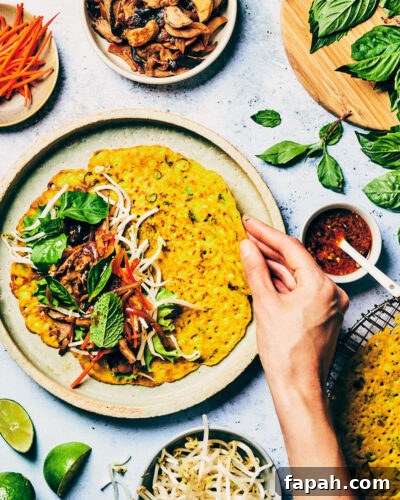 Crispy Banh Xeo Vietnamese Pancakes: How to Make Authentic Crepes 5 Crispy Vietnamese crepes being folded over