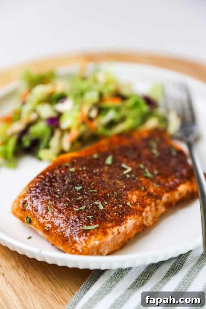 Sweet and Spicy Salmon in the Air Fryer: Quick Crispy Recipe 2 A white dinner plate with sweet and spicy air fryer salmon. salmon air fryer how to.