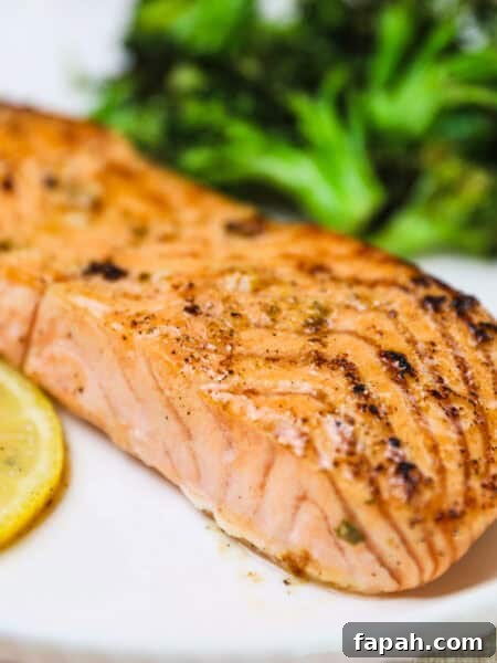 Sweet and Spicy Salmon in the Air Fryer: Quick Crispy Recipe 8 lemon garlic salmon recipe on a white plate and broccoli