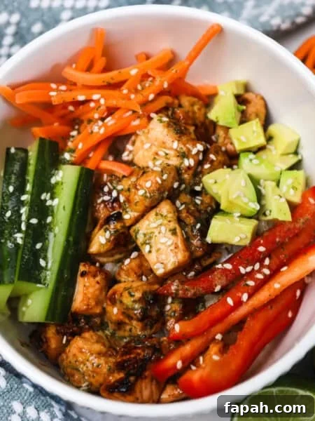 Sweet and Spicy Salmon in the Air Fryer: Quick Crispy Recipe 9 honey citrus salmon bowls recipe, salmon with sliced fresh veggies on rice.
