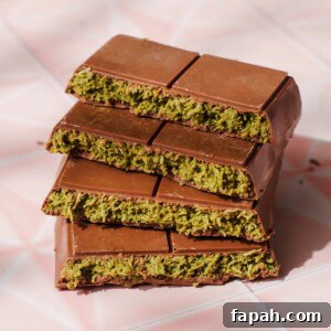 Dubai-Style Chocolate Bar Recipe: Homemade Candy Bar Guide 14 Dubai chocolate bars stacked together on a pink background.