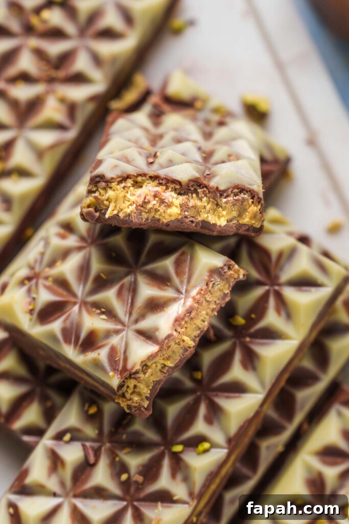 Dubai-Style Chocolate Bar Recipe: Homemade Candy Bar Guide 3 Dubai chocolate bar pieces on a board with chocolate bars.