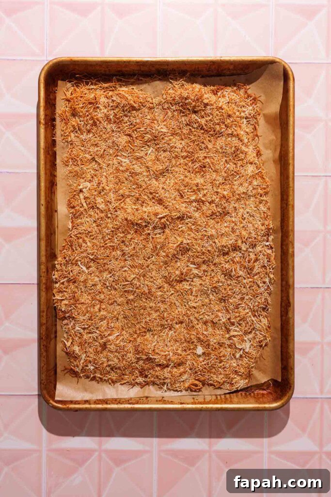 Dubai-Style Chocolate Bar Recipe: Homemade Candy Bar Guide 8 browned kataifi on a baking sheet.