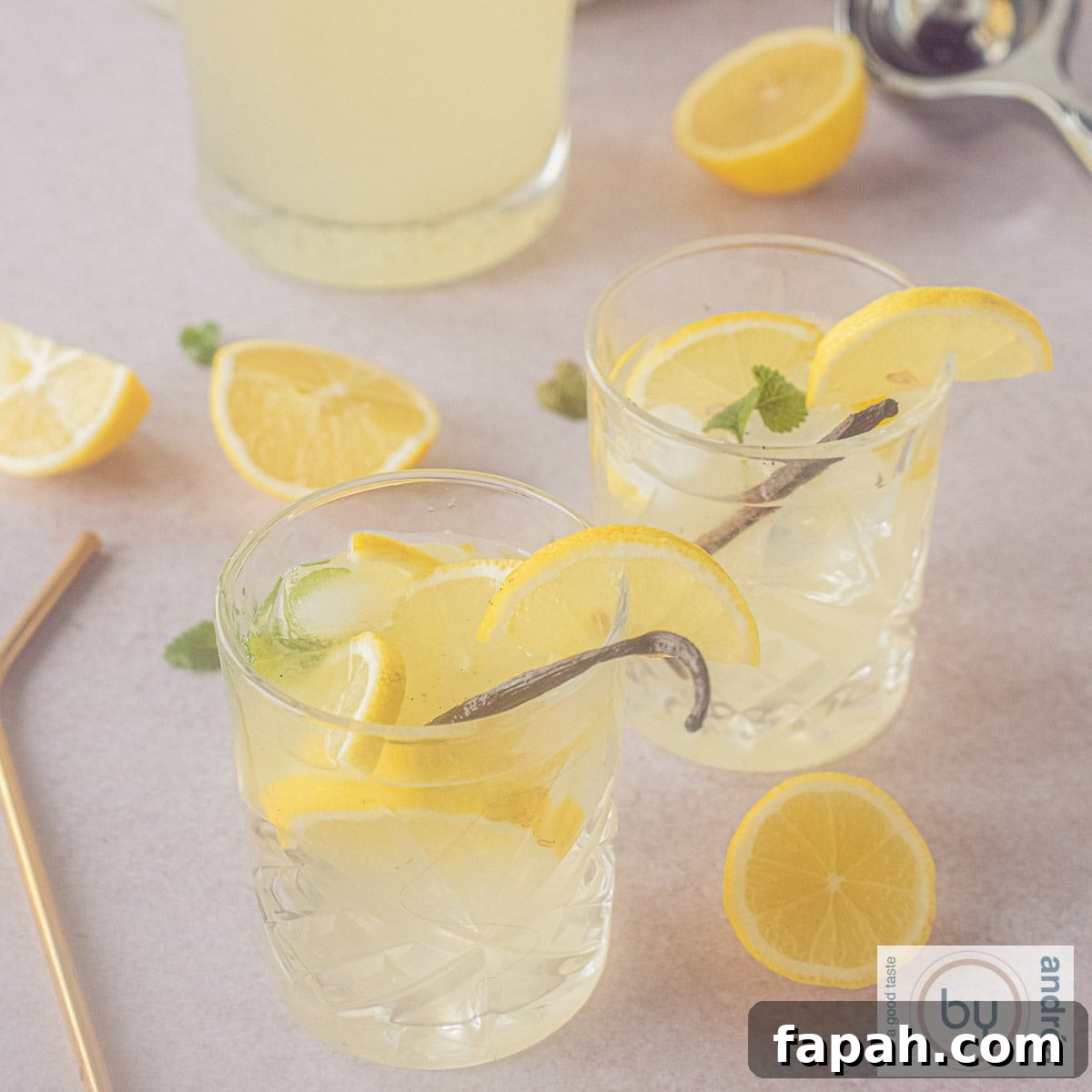 Vanilla Lemonade Recipe: Refreshing Homemade Citrus Cooler 9 A square picture of two glasses of lemonade with vanilla and lemon and mint.