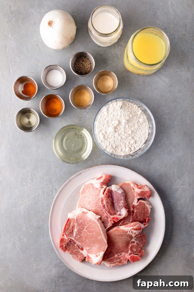 southern smothered pork chops ingredients. one onion, heavy cream, chicken broth, spices, all purpose flour, cooking oil, and pork chops