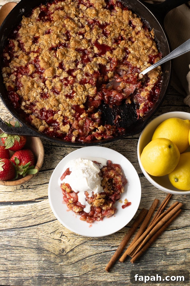 strawberry crisp topped with crisp oatmeal in a cast iron skillet