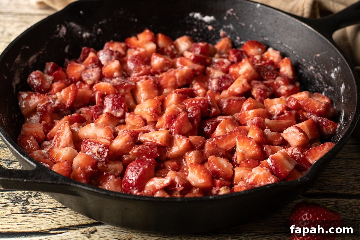 strawberries coated in flour, sugar in a cast iron pan