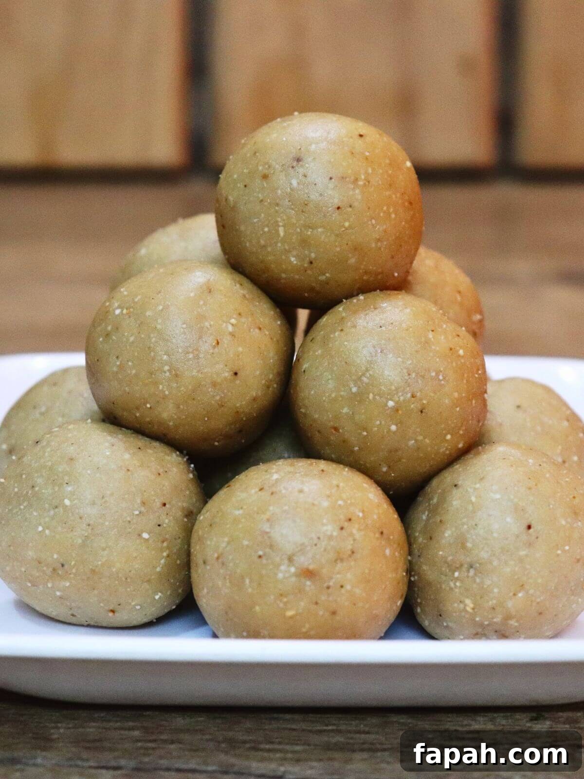 Peanut ladoo, stacked and served on a plate.