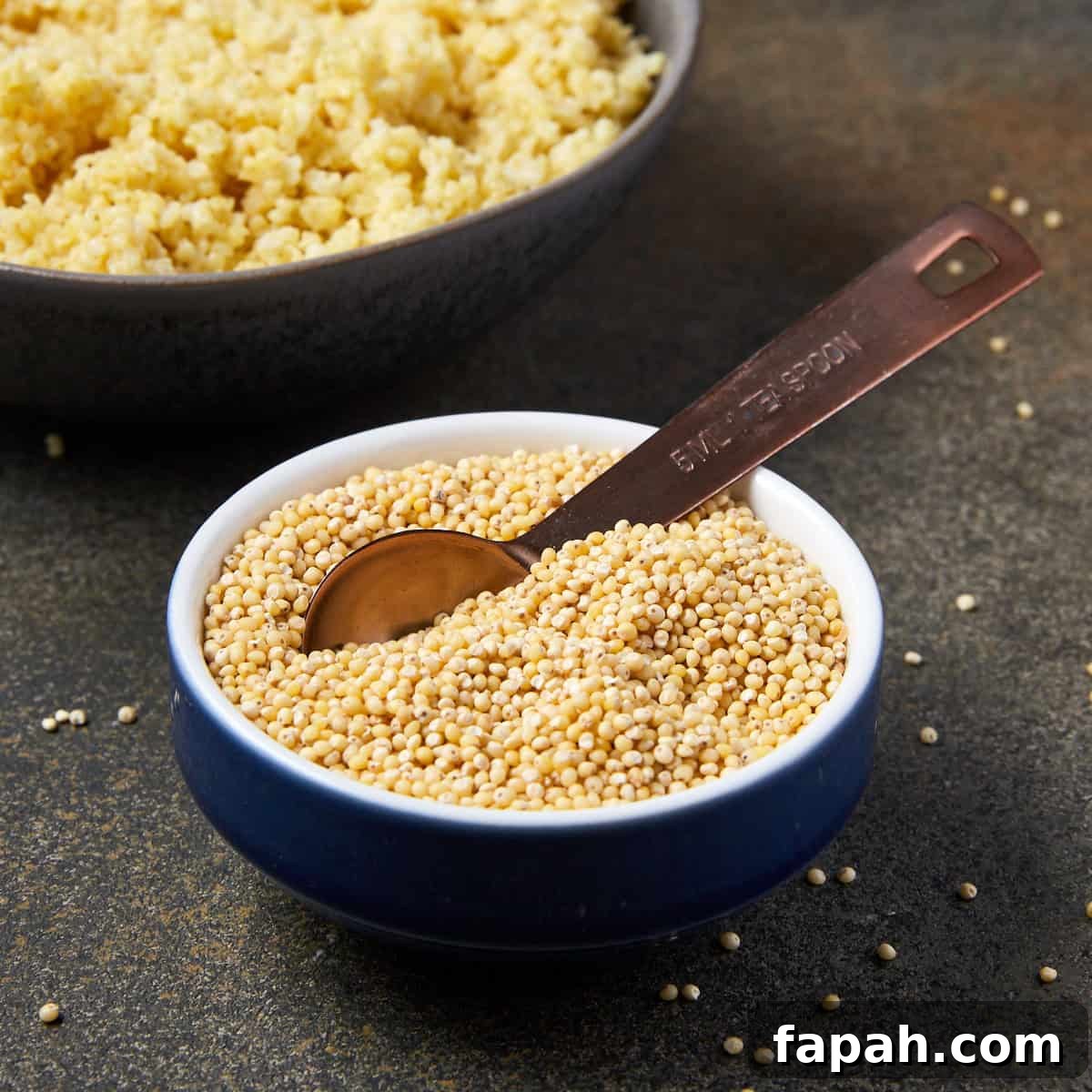 Pinterest graphic showing a bowl of raw millet with cooked millet in the background.