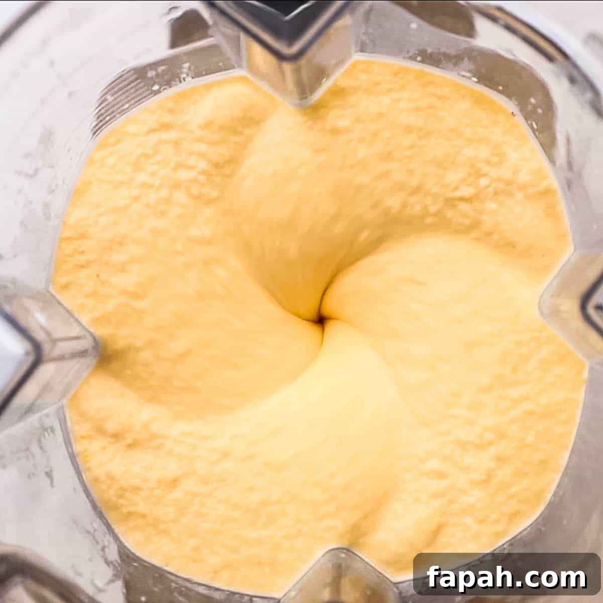 Creamy Peach Banana Smoothie Recipe for Refreshing Mornings 6 Blending smoothie ingredients together.