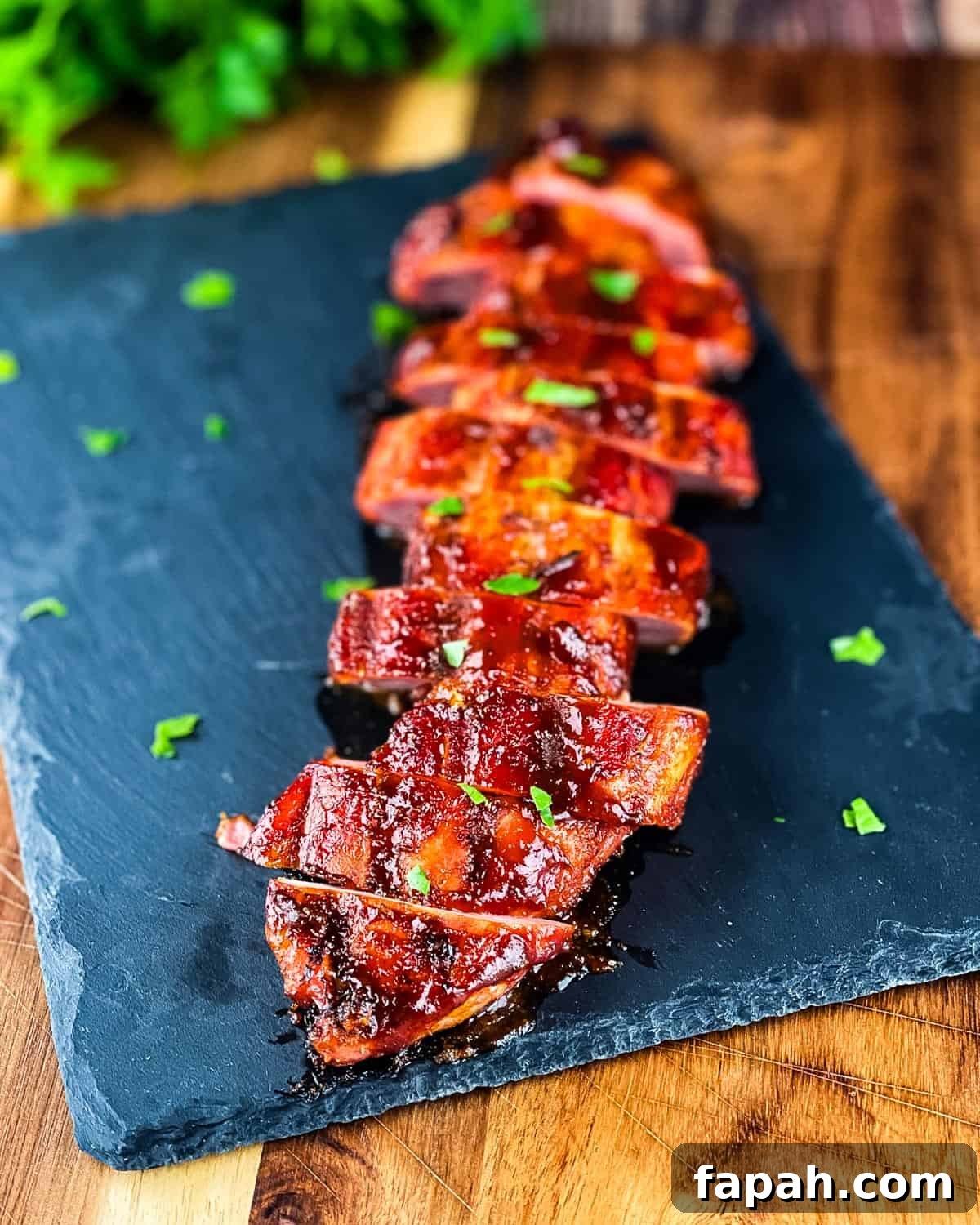 Juicy smoked tenderloin sliced and placed on a serving platter.