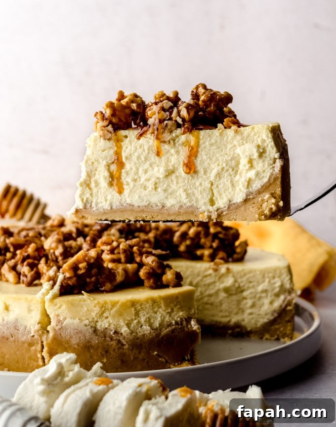 Goat Cheese Cheesecake with Roasted Honey Walnut Topping 7 A person slicing and serving a slice of goat cheese cheesecake with honey walnut topping.
