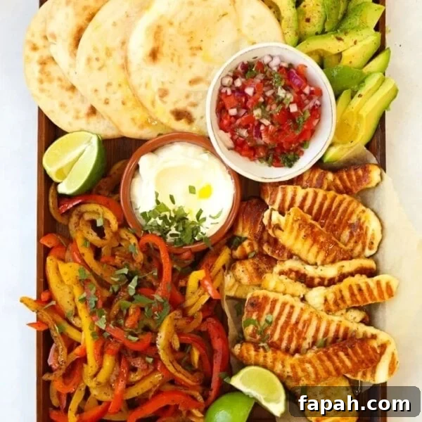 Halloumi fajitas recipe on a board with tortilla wraps avocado and salsa.