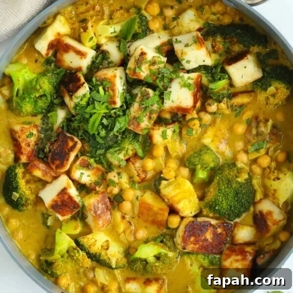 Pan full of delicious vegetarian curry made with halloumi, chickpeas and broccoli.