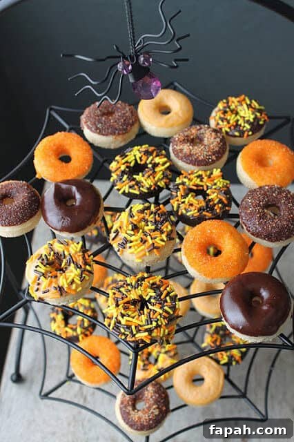 Spooky Halloween Donuts: Creative Recipes and Decorating Ideas 4 decorated mini halloween donuts on spider cake stand.