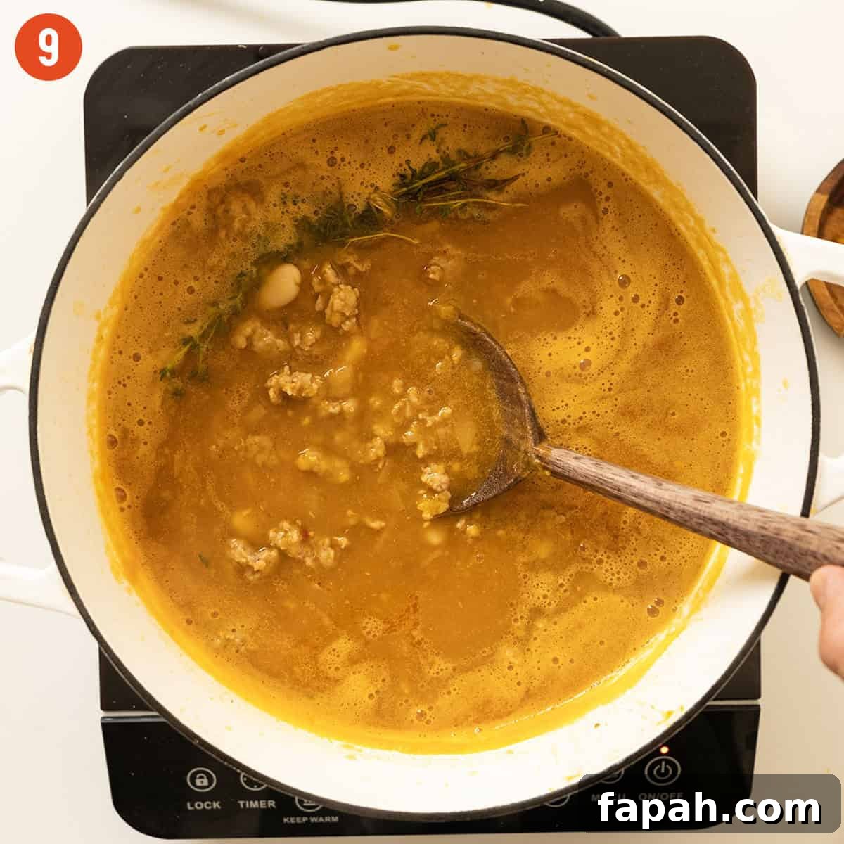 Creamy Butternut Squash and Sausage Soup Recipe 9 Simmering soup with sausage and beans.
