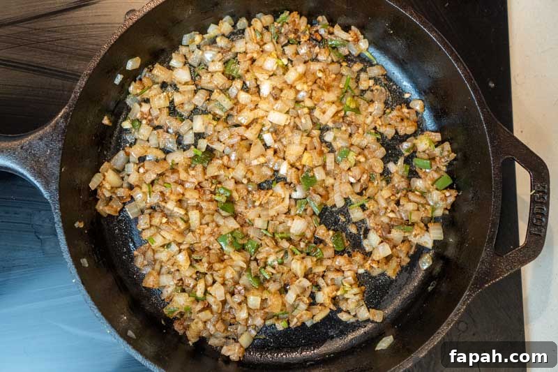 Cooking the garlic, cumin, cinnamon and lime zest